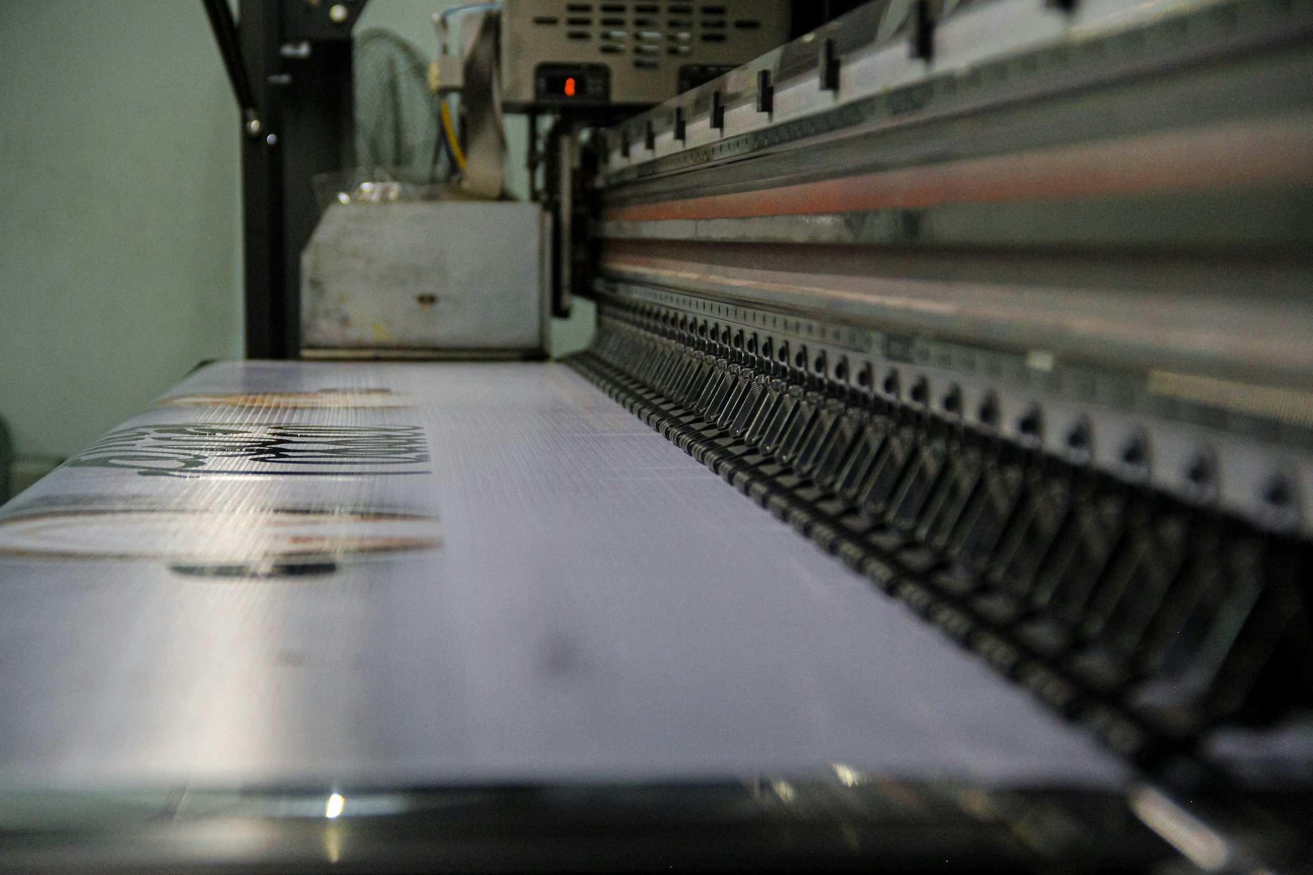 Close-up of automated canning equipment in a modern brewery assembly line.
